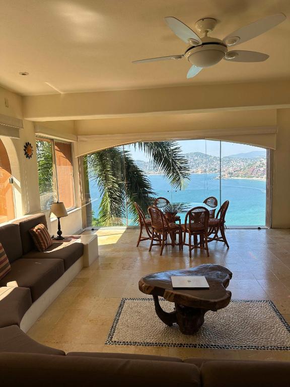 a living room with a couch and a table at Luxury Residence at Vista Bay 103 in Zihuatanejo