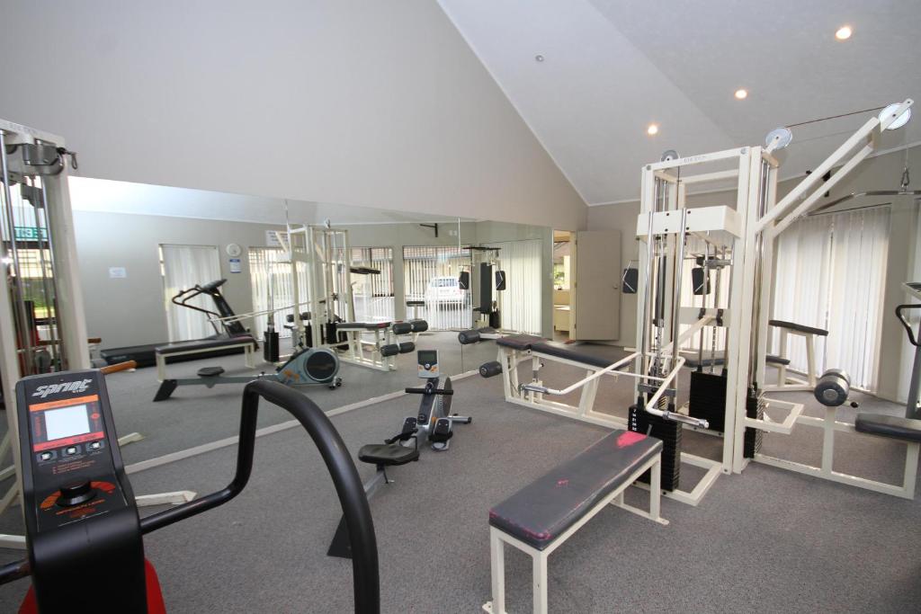 a gym with several treadmills and machines at Bentleys Motor Inn in Palmerston North
