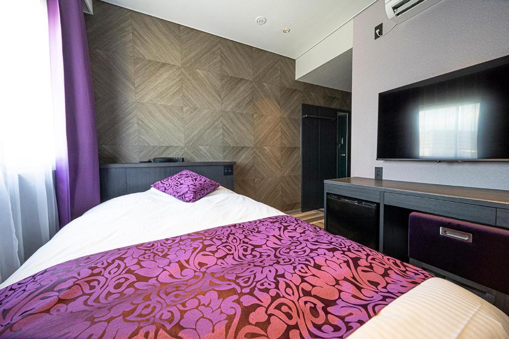 Postel nebo postele na pokoji v ubytování Kojima Puchi Hotel