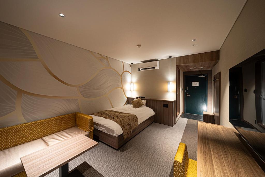 Postel nebo postele na pokoji v ubytování Kojima Puchi Hotel