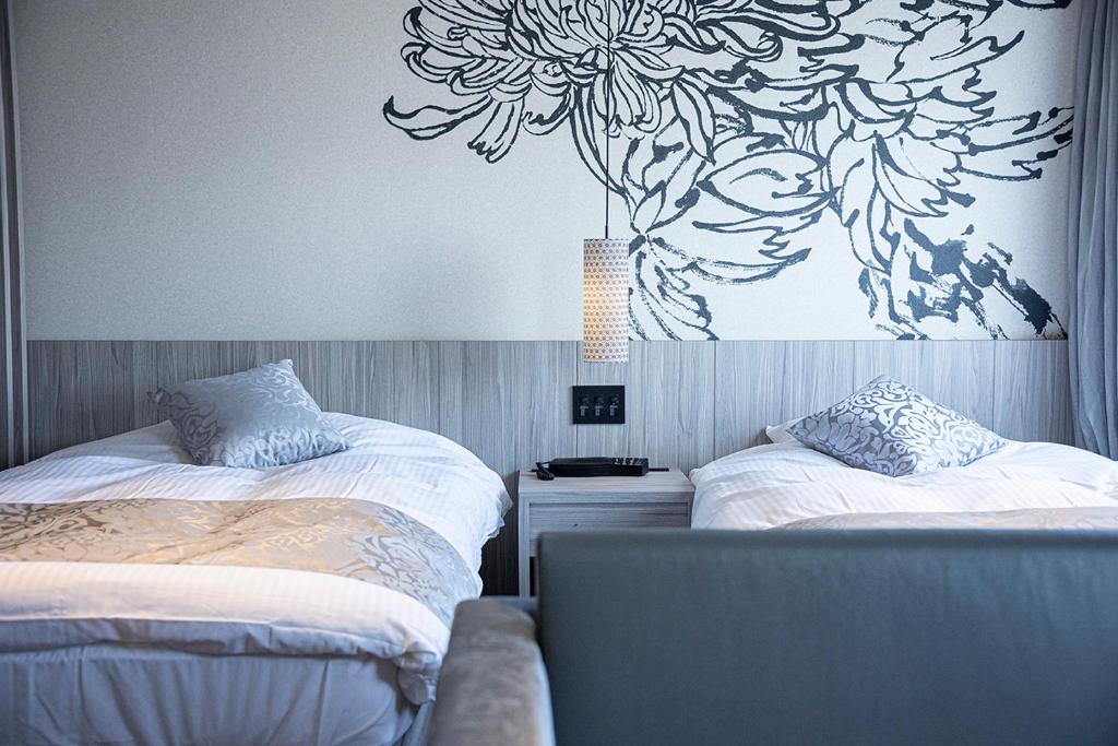Postel nebo postele na pokoji v ubytování Kojima Puchi Hotel