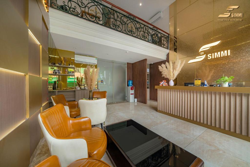 a lobby of a restaurant with chairs and a counter at Simmi 6 Hotel & Apartment in Ho Chi Minh City