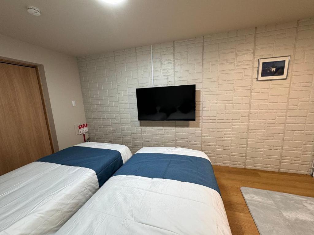 Postel nebo postele na pokoji v ubytování Comfy House Namba