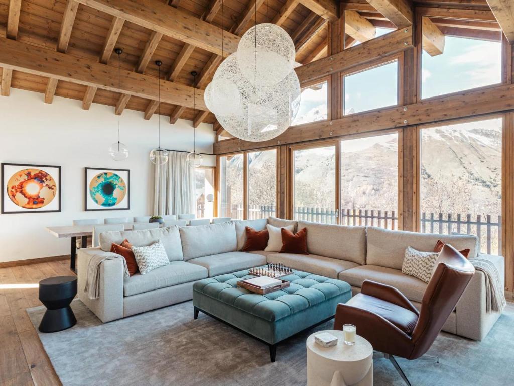 a living room with a couch and a table at Chalet rénové avec sauna, salle de sport et navette gratuite - FR-1-613B-50 in Saint-Martin-de-Belleville