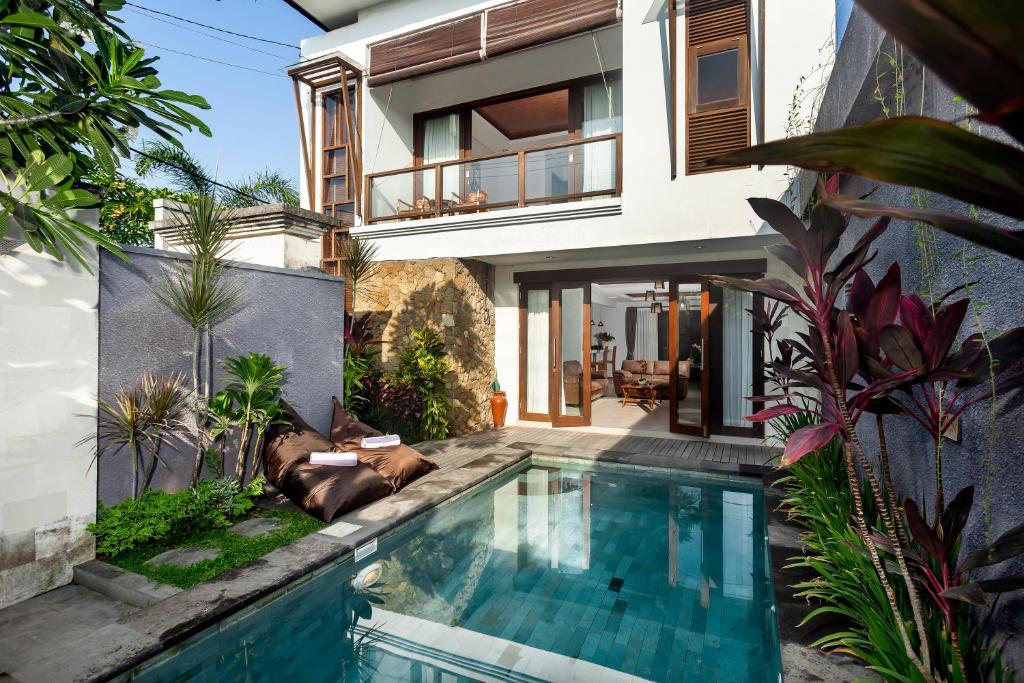 a swimming pool in the backyard of a house at Samtana Villas in Ubud