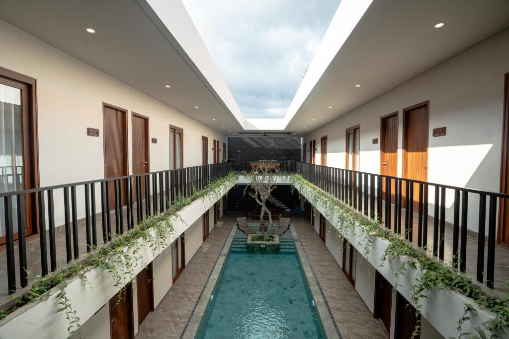 an indoor pool in the middle of a building at Miles Coliving Bali, close to Seminyak and Canggu in Kerobokan