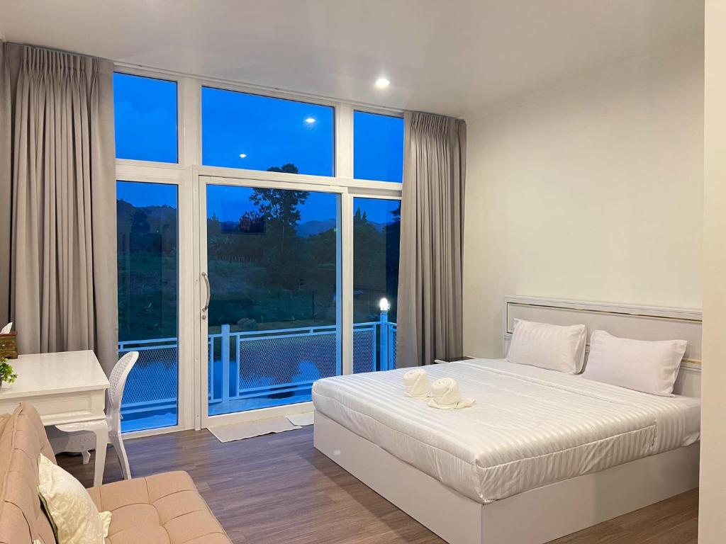 Ένα ή περισσότερα κρεβάτια σε δωμάτιο στο Quality Time Farmstay Deluxe Room
