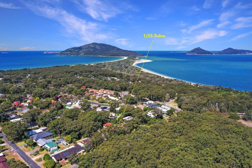 an aerial view of a beach with houses and the ocean at Close to Jimmys Beach in Hawks Nest