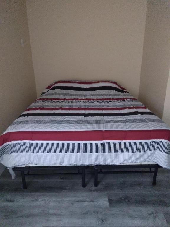 a bed sitting in a corner of a room at Mabel place in Lakewood