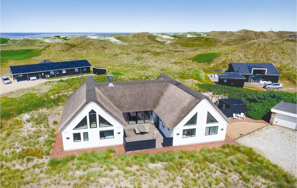 an aerial view of a house in a field at Lovely Home In Ringkøbing With Sauna in Ringkøbing