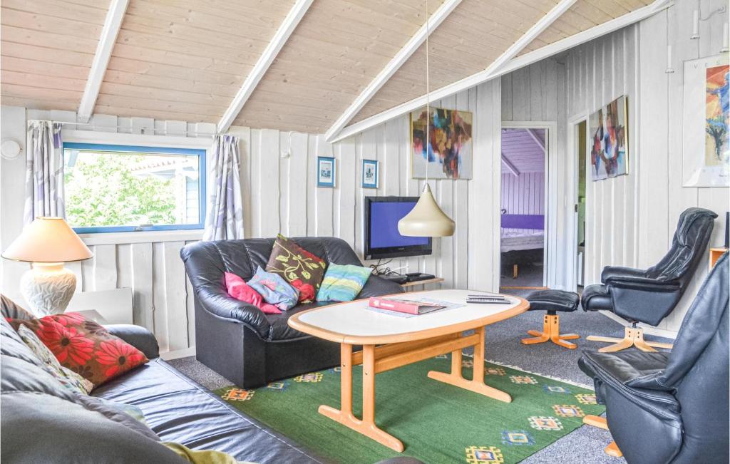 a living room with a couch and a table and chairs at 3 Bedroom Nice Home In Hemmet in Hemmet