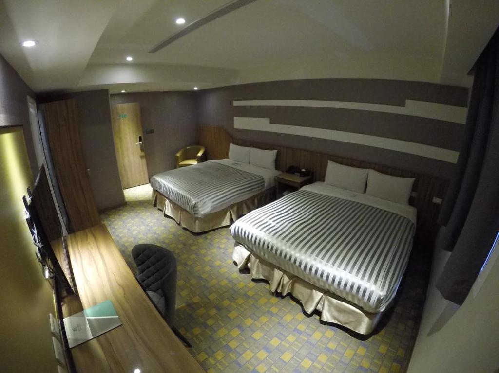 Postel nebo postele na pokoji v ubytování Ximen Hotel B