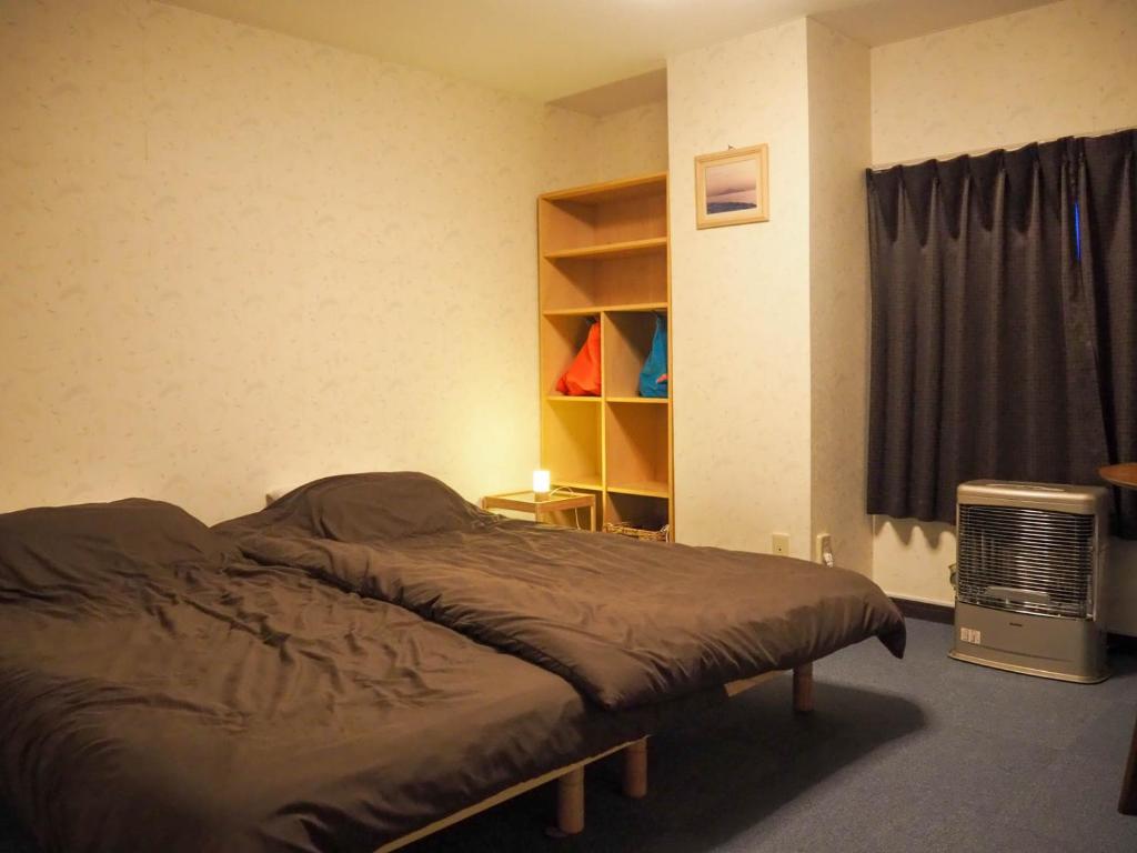 Postel nebo postele na pokoji v ubytování Guest House Moshiripa