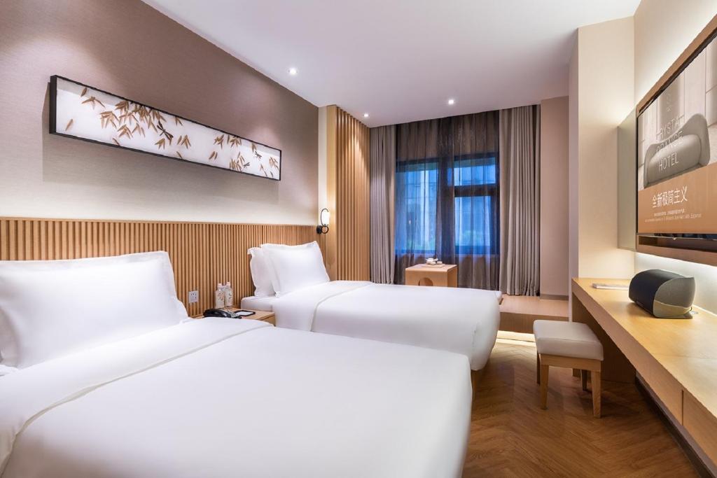 Postel nebo postele na pokoji v ubytování 桔子水晶北京王府井大街酒店