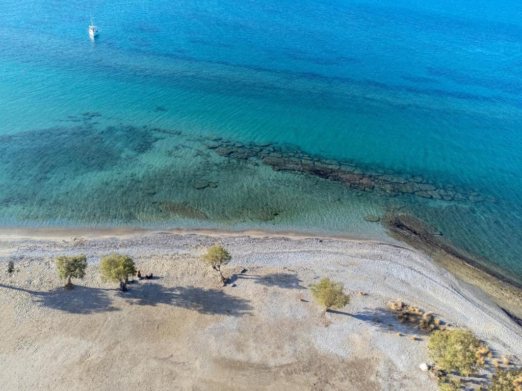 an aerial view of a beach with trees in the water at Agistri Hotel in Skala