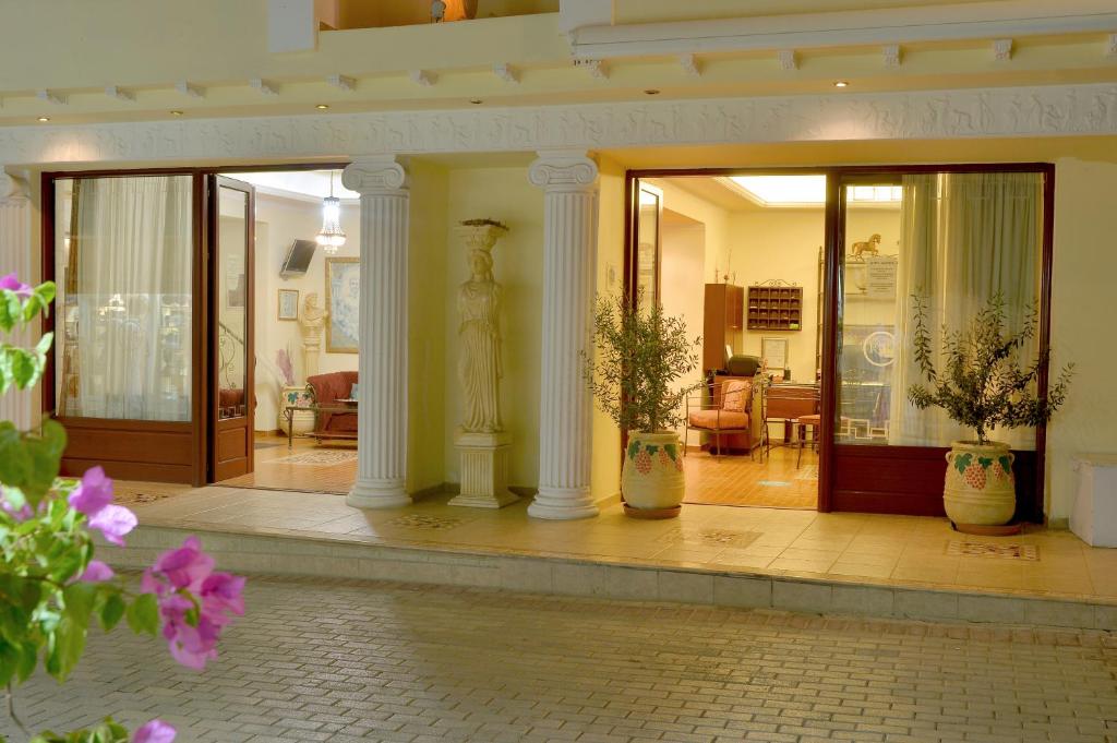 a lobby with two vases with plants in it at Agistri Hotel in Skala