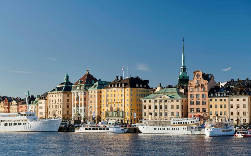 a group of boats docked in a harbor with buildings at Hôtel Reisen in The Unbound Collection by Hyatt in Stockholm