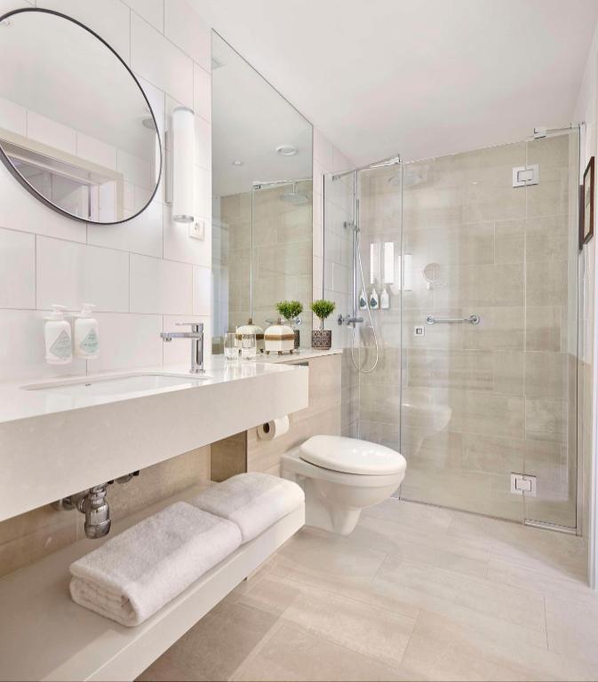a bathroom with a toilet and a sink and a shower at Hôtel Reisen in The Unbound Collection by Hyatt in Stockholm