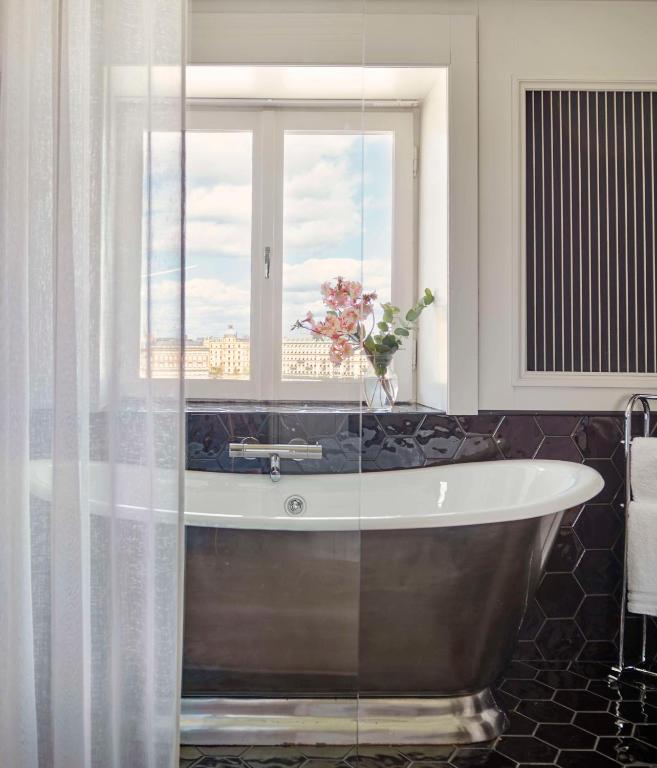 a bath tub in a bathroom with a window at Hôtel Reisen in The Unbound Collection by Hyatt in Stockholm