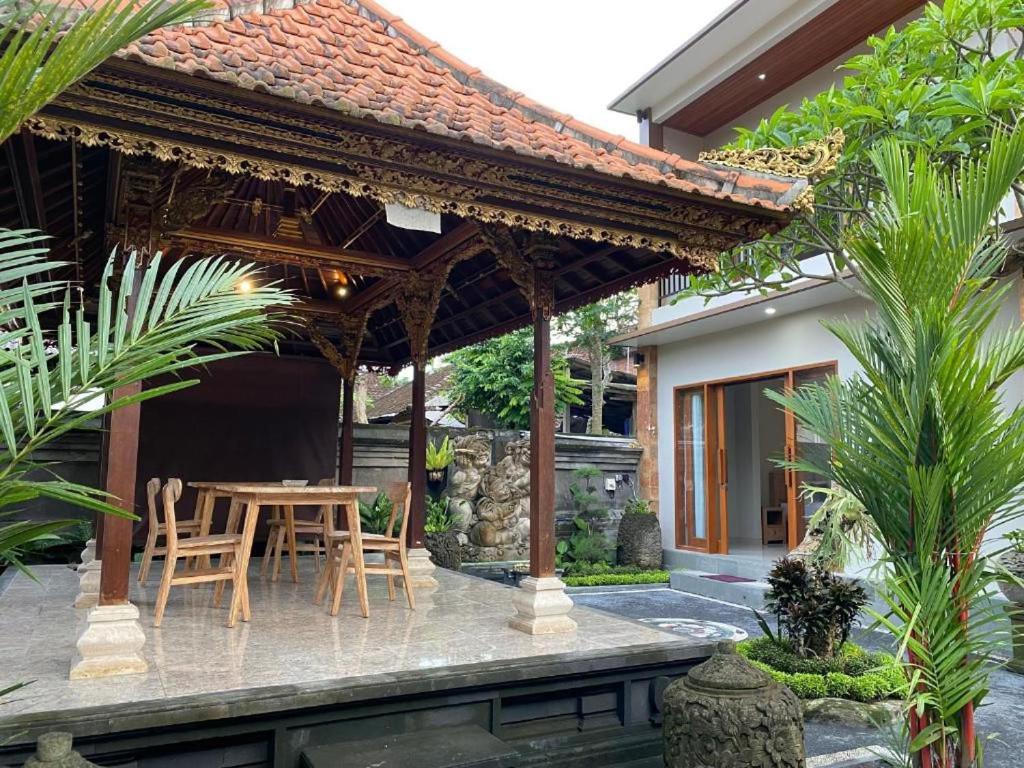 a pavilion with a table and chairs on a patio at Wirana Guest House in Ubud