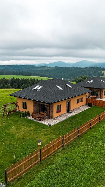a house with solar panels on it in a field at North Resorts Lucas in Novoť