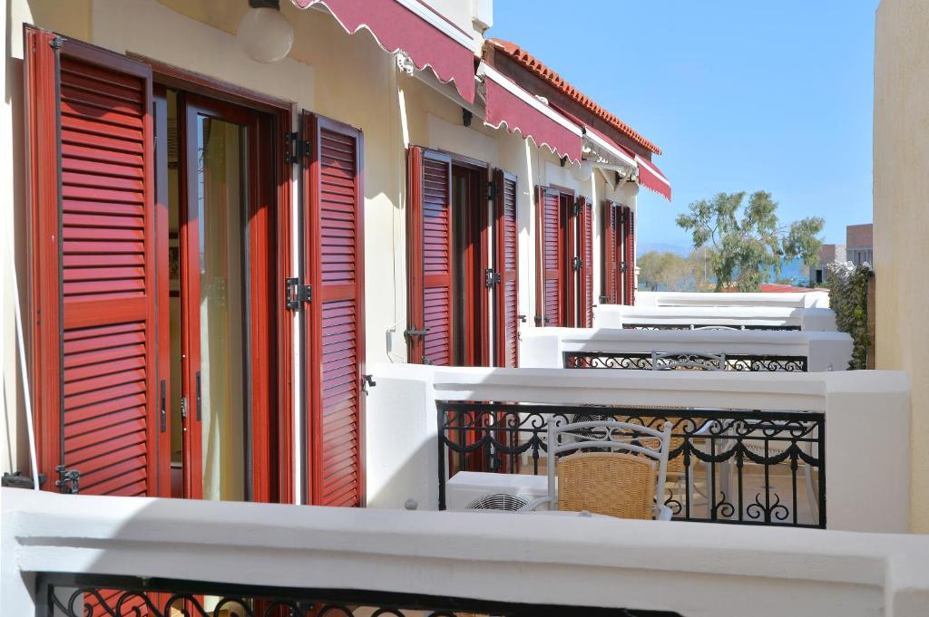 a row of shuttered windows on a building at Agistri Hotel in Skala