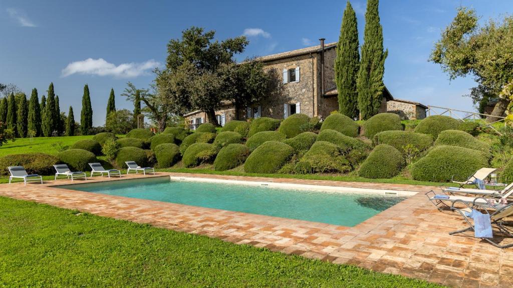 a swimming pool in the yard of a house at VILLA DEI ROSMARINI 8, Emma Villas in Orvieto