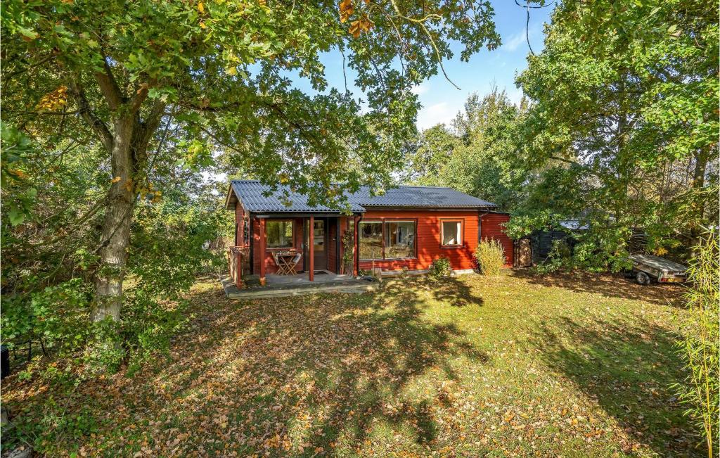 a small red cabin in the middle of a yard at Amazing Home In Rødby With Wifi in Rødby