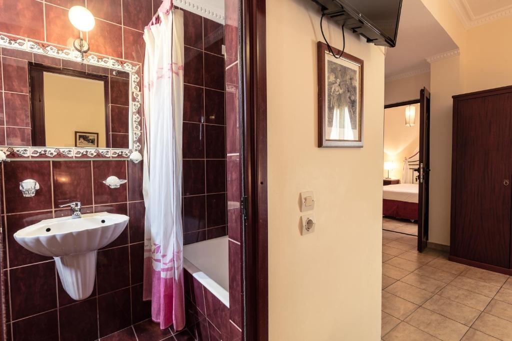 a bathroom with a sink and a shower at Agistri Hotel in Skala