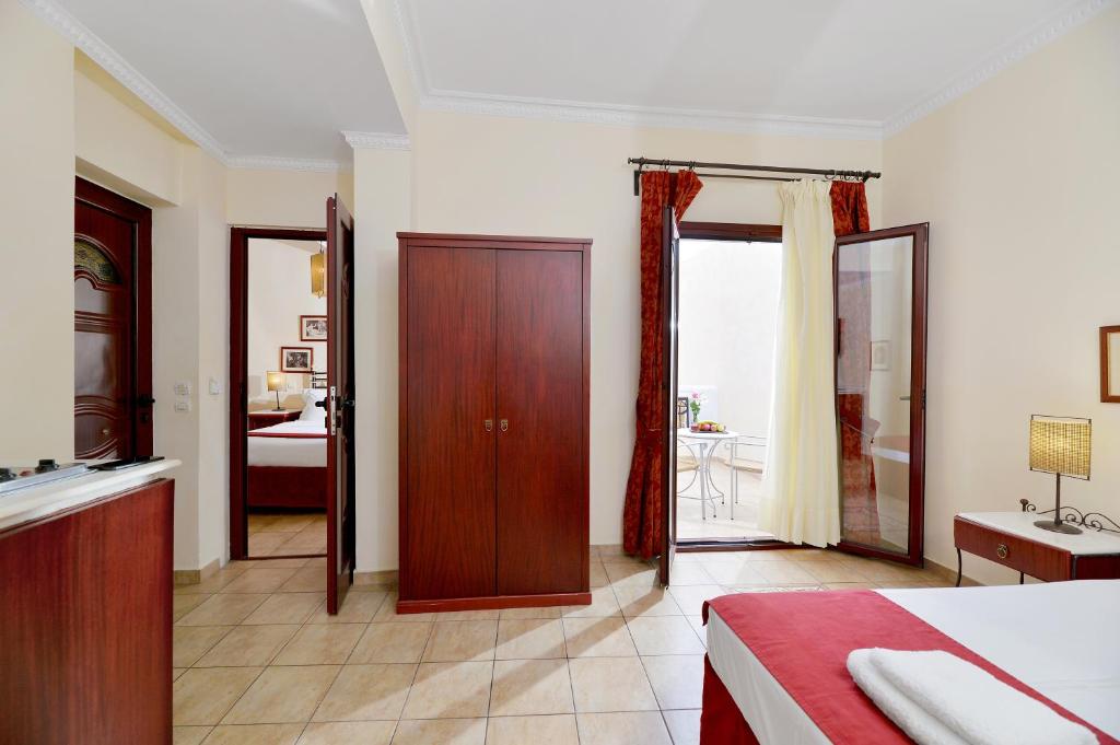 a bedroom with a bed and a bathroom at Agistri Hotel in Skala
