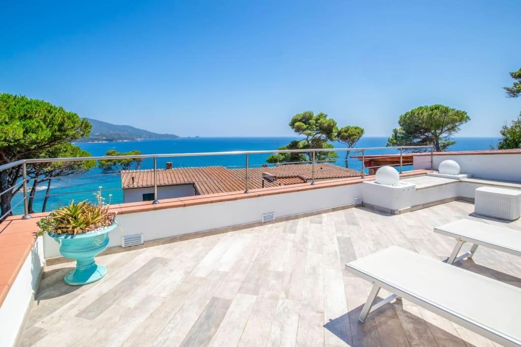 a view of the ocean from the balcony of a house at Villa Denise in Capoliveri