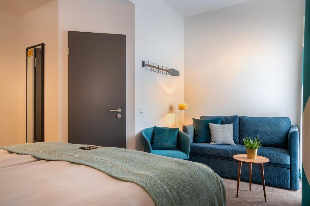 Postel nebo postele na pokoji v ubytování Hotel Hansestadt Lübeck