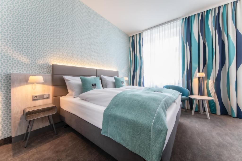 Postel nebo postele na pokoji v ubytování Hotel Hansestadt Lübeck