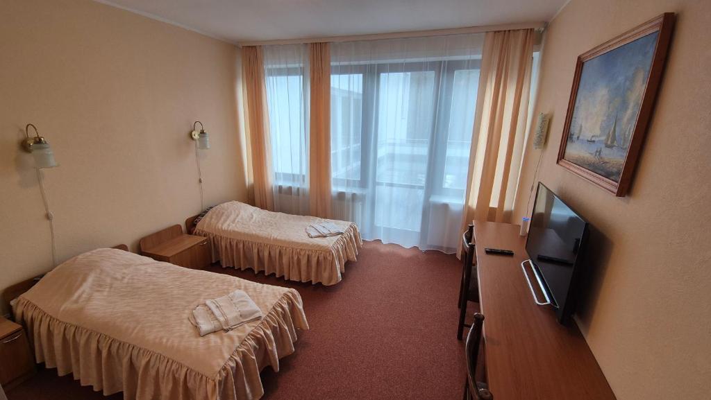 Postel nebo postele na pokoji v ubytování Narva-Jõesuu Beach Residence
