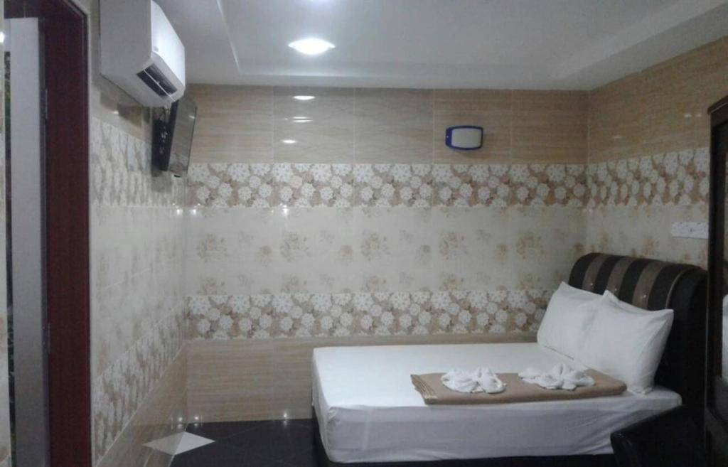 Postel nebo postele na pokoji v ubytování SV Andalas Hotel