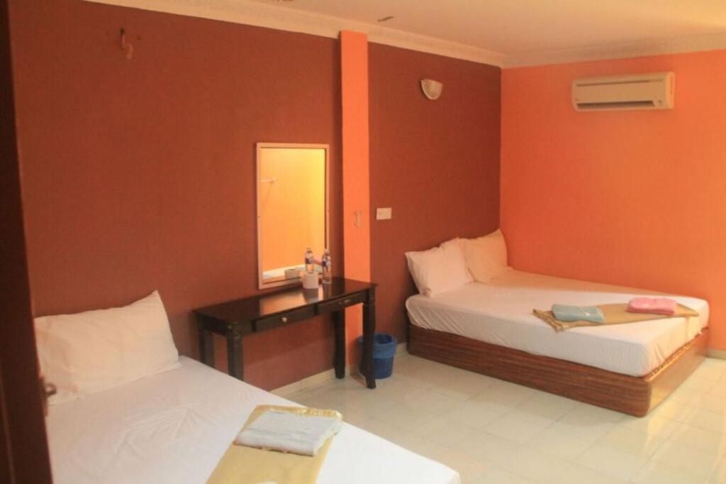 Postel nebo postele na pokoji v ubytování SV Andalas Hotel