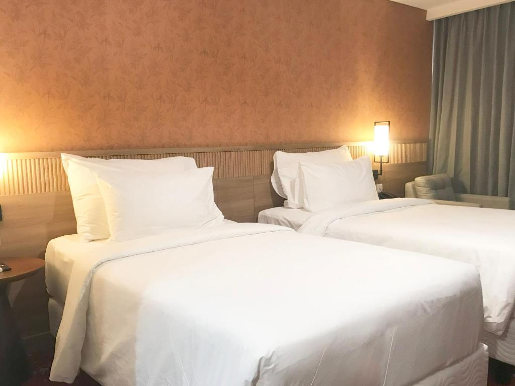 Postel nebo postele na pokoji v ubytování Labersa Hotel & Convention Center Samosir