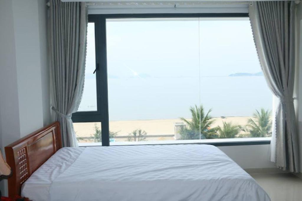 Postel nebo postele na pokoji v ubytování Huy Hoàng Hotel Đà Nẵng
