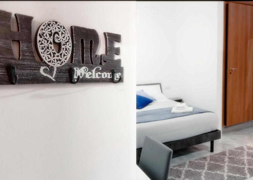 a bedroom with a bed and a sign on the wall at San Giovanni Apartment in Catanzaro