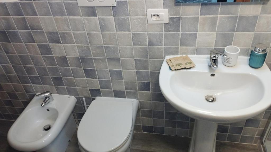a bathroom with a sink and a toilet at San Giovanni Apartment in Catanzaro