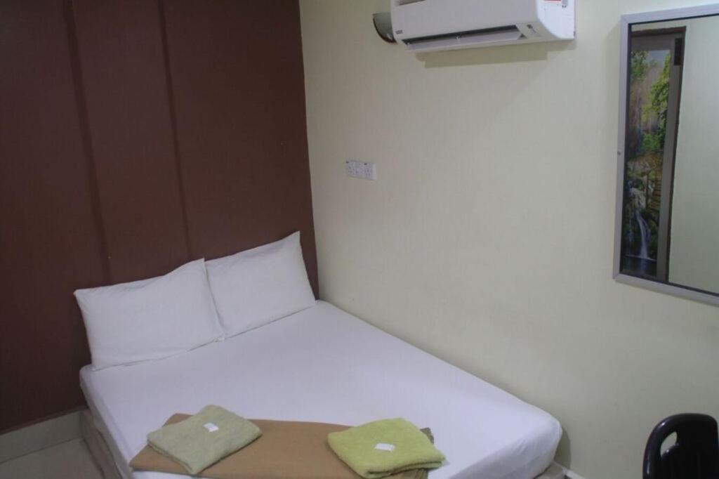 Postel nebo postele na pokoji v ubytování SV Andalas Hotel