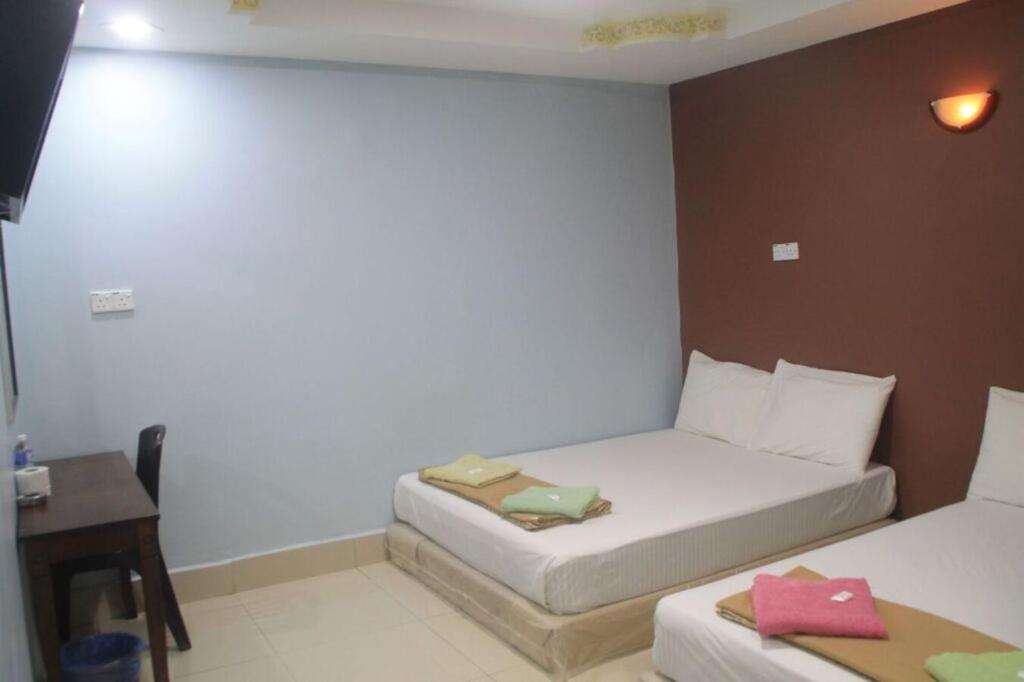Postel nebo postele na pokoji v ubytování SV Andalas Hotel