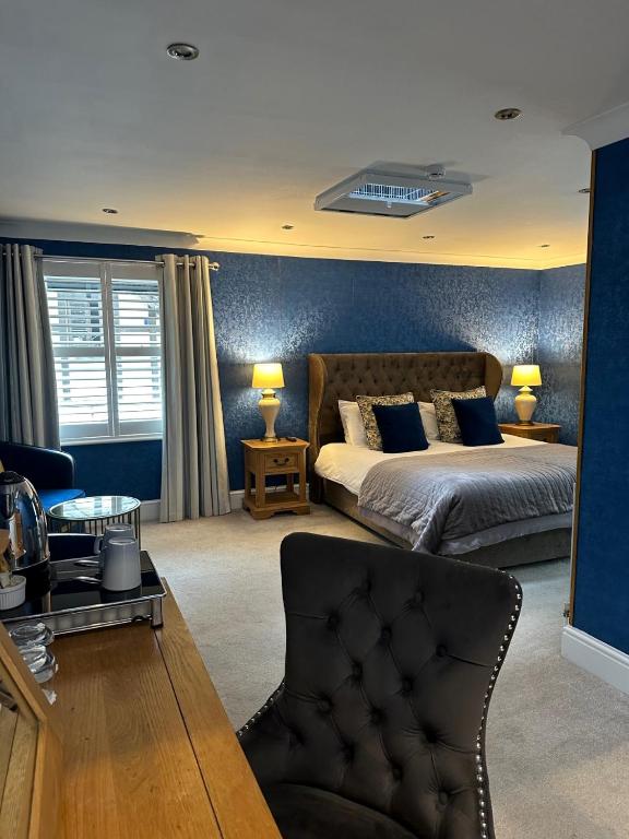a large bedroom with a bed and a couch at Derby Manor in Bournemouth
