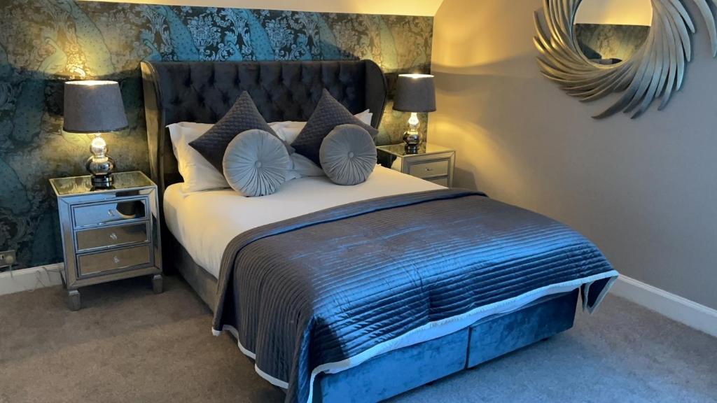 a bedroom with a large bed with two night stands at Derby Manor in Bournemouth