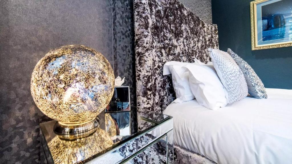 a bedroom with a bed and a gold disco ball at Derby Manor in Bournemouth
