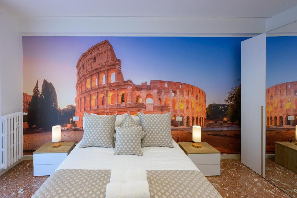 a bedroom with a bed with a painting of the coliseum at Luxury Suite-Metro Malatesta in Rome