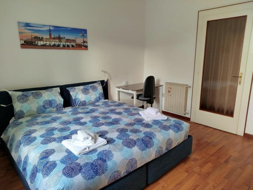 a bedroom with a bed with two towels on it at Moderno appartamento sulle Rive in Trieste