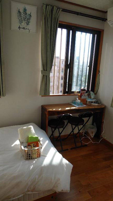 Llit o llits en una habitació de リンゴテラス壺屋