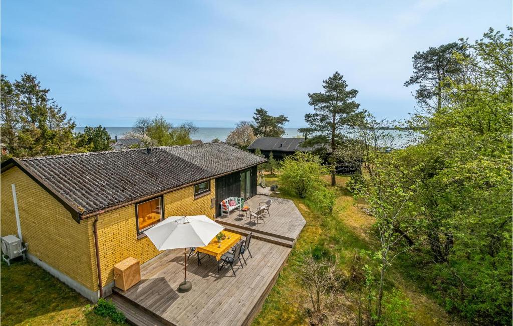 an overhead view of a yellow house with a deck at Cozy Home In Nexø With House Sea View in Neksø