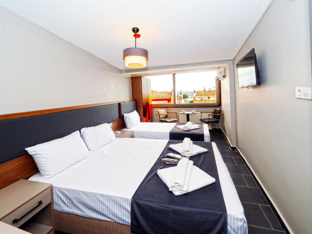 a hotel room with two beds with napkins on them at Diamond Hotel in Istanbul